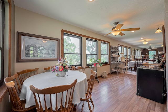 dining room featuring a ceiling fan, baseboards, recessed lighting, and light wood-style floors