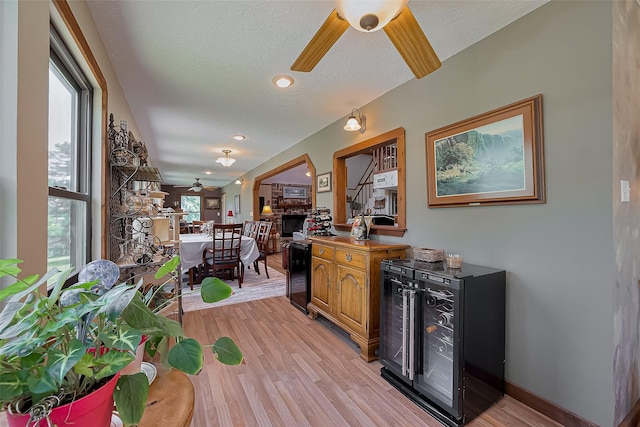 bar featuring a ceiling fan, recessed lighting, wine cooler, and light wood-style flooring