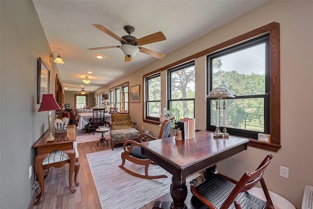 dining space with light wood-type flooring, recessed lighting, and ceiling fan
