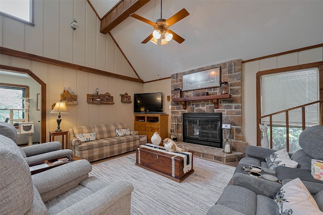 living room with a fireplace, a decorative wall, a wealth of natural light, and a ceiling fan