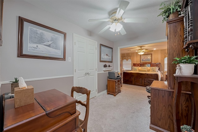 interior space featuring light carpet and ceiling fan