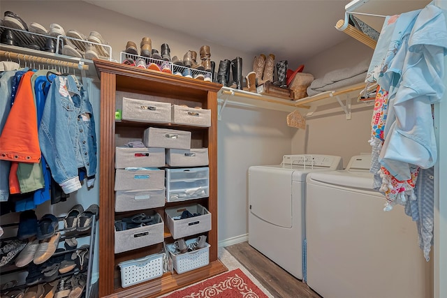 washroom with wood finished floors, separate washer and dryer, and laundry area