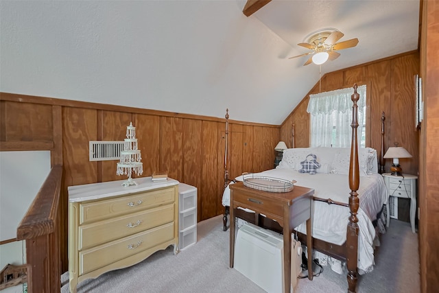 bedroom featuring light carpet, wooden walls, and vaulted ceiling