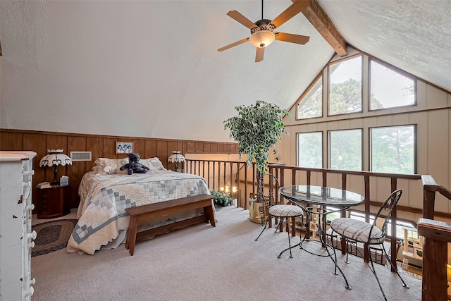 carpeted bedroom with vaulted ceiling with beams, visible vents, wooden walls, and a wainscoted wall