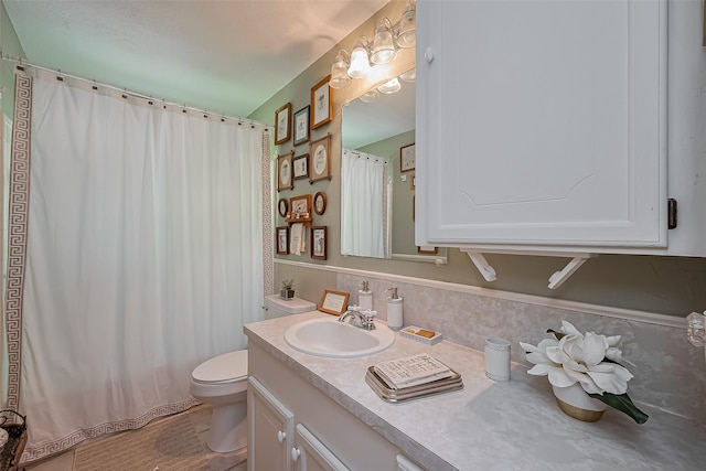 full bathroom featuring toilet, vanity, and curtained shower