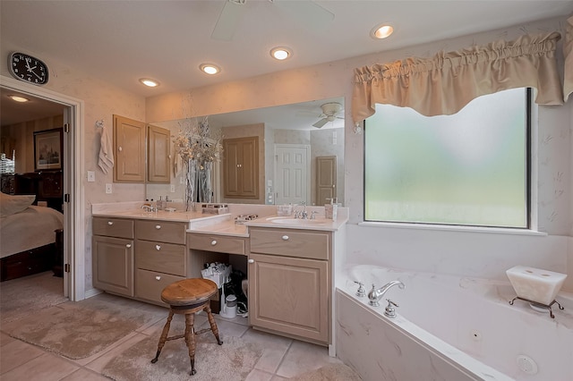 ensuite bathroom with a sink, double vanity, a jetted tub, tile patterned flooring, and ceiling fan