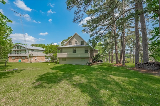 back of house with a lawn