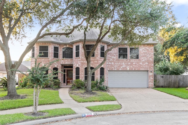 2529 La Rochelle Ct, Seabrook, TX 77586 - french provincial home featuring an attached garage, driveway, brick siding, and roof with shingles