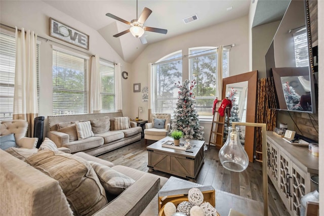 living room featuring hardwood / wood-style flooring, ceiling fan, vaulted ceiling, and visible vents