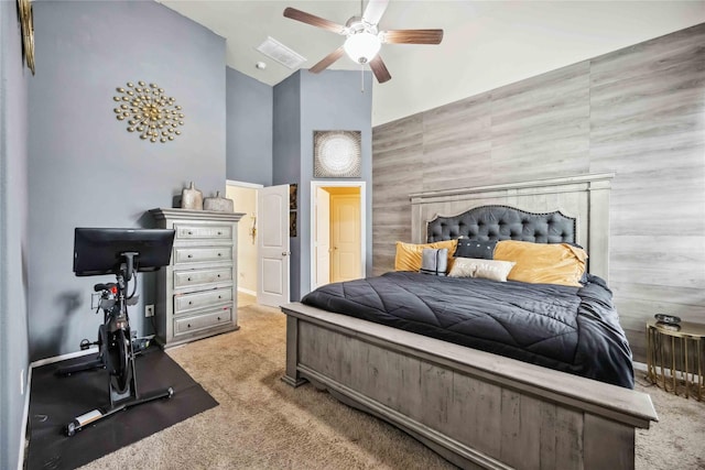 carpeted bedroom with high vaulted ceiling, ceiling fan, and baseboards
