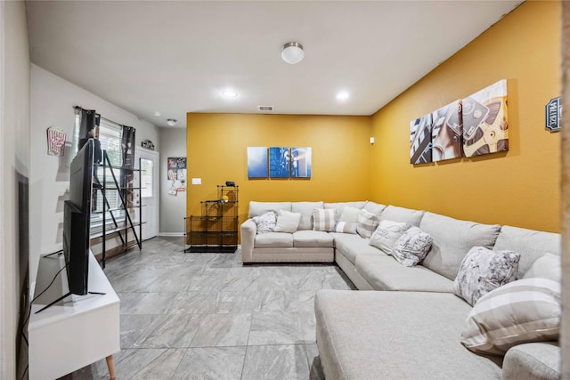 living area with recessed lighting, visible vents, and baseboards