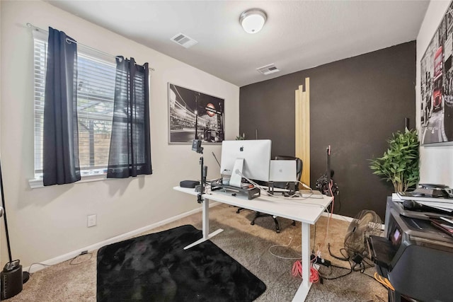 home office featuring carpet floors, visible vents, and baseboards