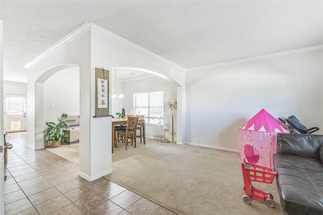 2702 Lakecrest Way Dr, Katy, TX 77493 - carpeted living area featuring tile patterned floors, baseboards, arched walkways, and crown molding