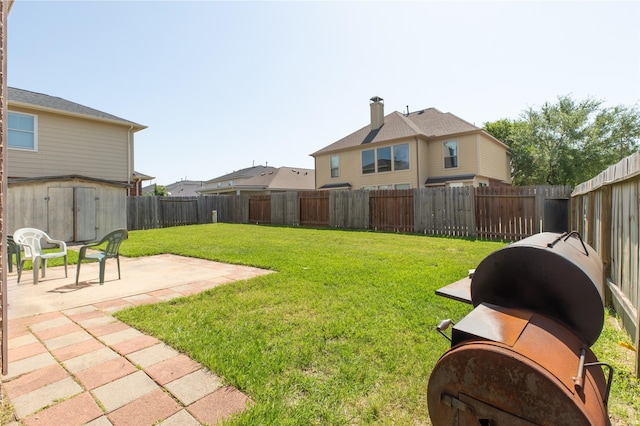 2702 Lakecrest Way Dr, Katy, TX 77493 - view of yard featuring an outdoor structure, a storage unit, a patio area, and a fenced backyard