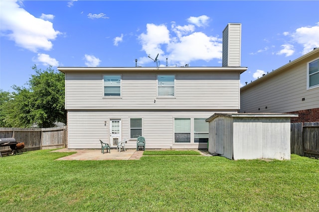 2702 Lakecrest Way Dr, Katy, TX 77493 - rear view of house featuring a lawn, a patio area, a fenced backyard, and a storage unit
