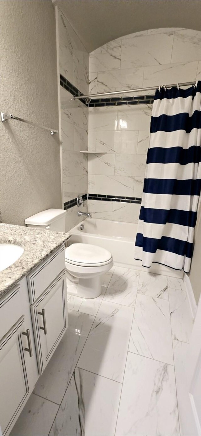 2711 Wollemi Pine Trl, Katy, TX 77493 - full bathroom featuring toilet, shower / tub combo, marble finish floor, a textured wall, and vanity