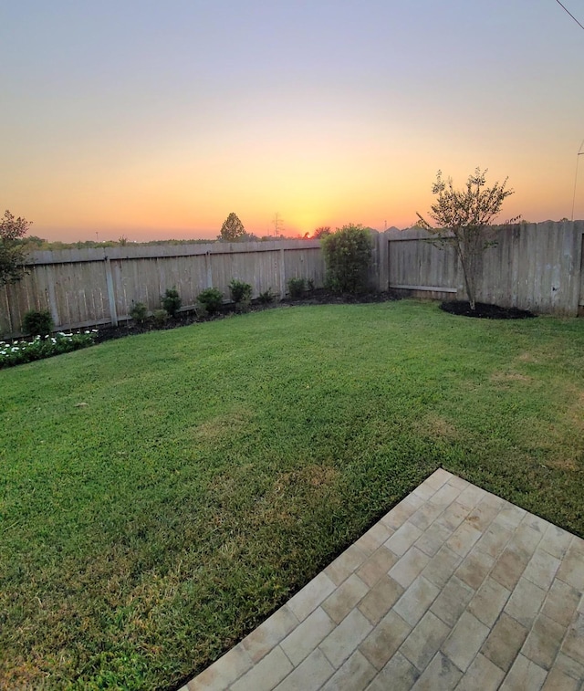 2711 Wollemi Pine Trl, Katy, TX 77493 - yard at dusk featuring a patio area and a fenced backyard