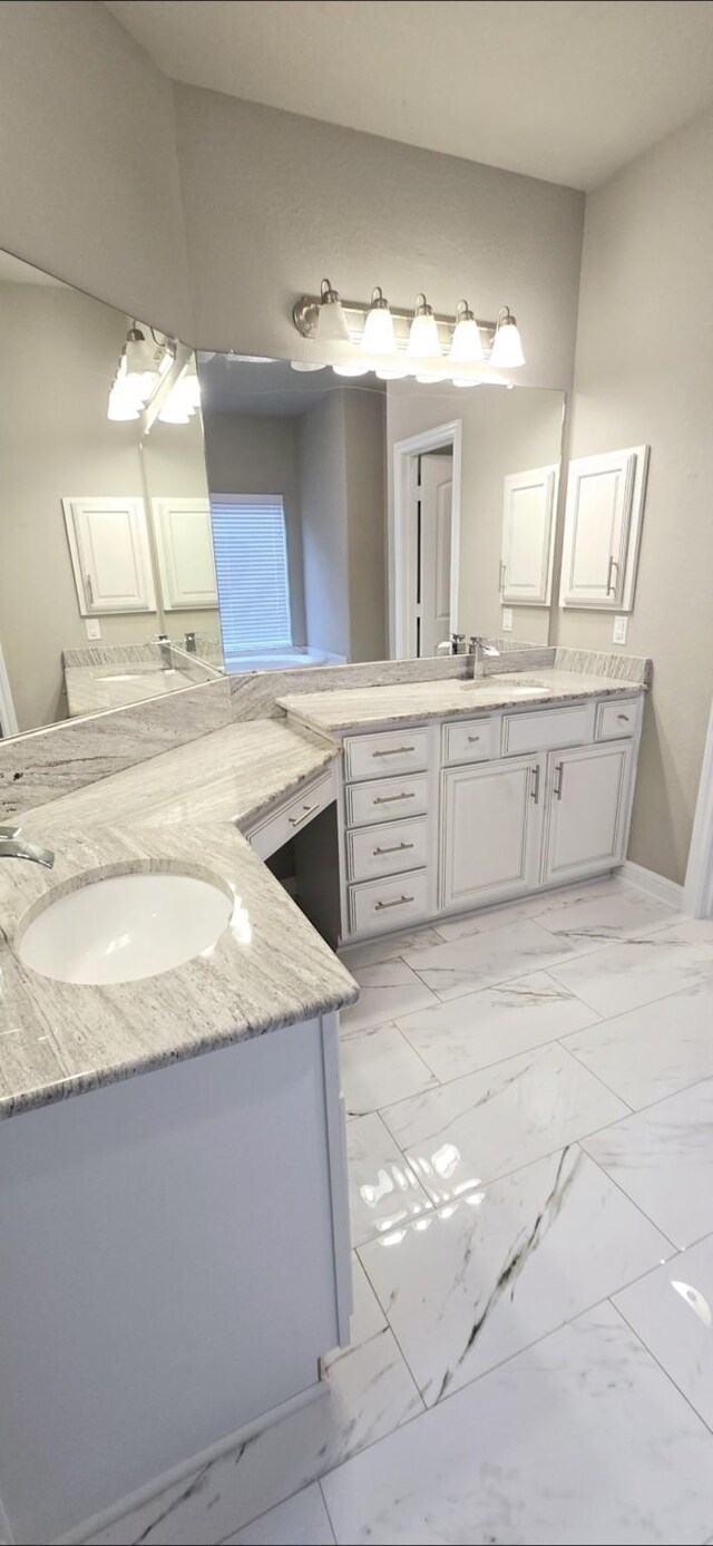 2711 Wollemi Pine Trl, Katy, TX 77493 - full bath featuring two vanities, baseboards, marble finish floor, and a sink