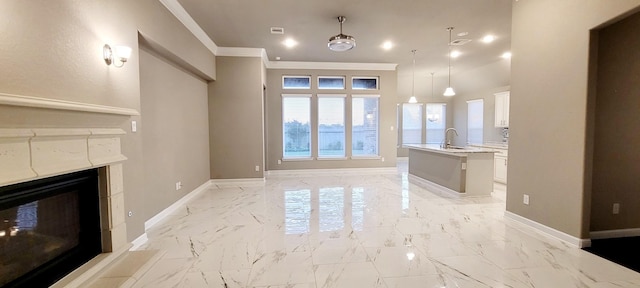 2711 Wollemi Pine Trl, Katy, TX 77493 - unfurnished living room featuring a multi sided fireplace, baseboards, ornamental molding, and a sink