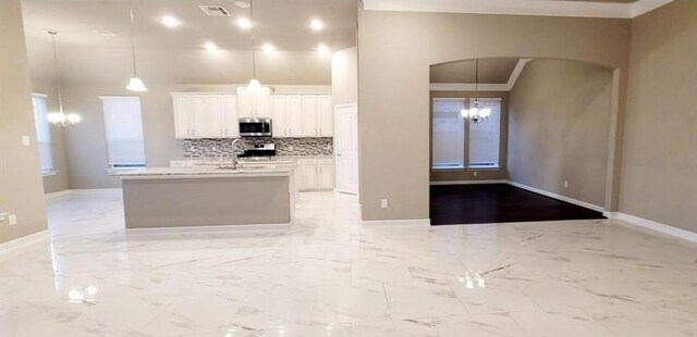 2711 Wollemi Pine Trl, Katy, TX 77493 - kitchen featuring white cabinets, a chandelier, stainless steel microwave, baseboards, and visible vents
