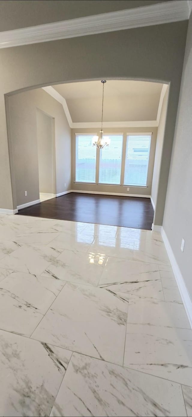 2711 Wollemi Pine Trl, Katy, TX 77493 - spare room featuring a chandelier, marble finish floor, baseboards, and ornamental molding