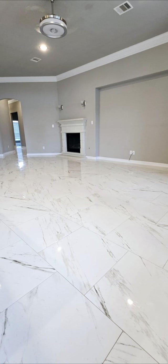 2711 Wollemi Pine Trl, Katy, TX 77493 - unfurnished living room featuring visible vents, baseboards, marble finish floor, crown molding, and a fireplace