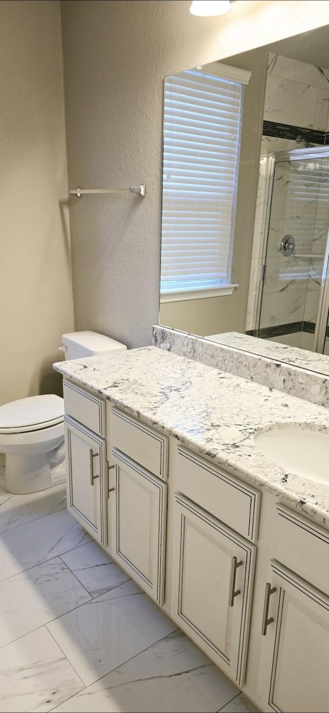 2711 Wollemi Pine Trl, Katy, TX 77493 - full bathroom with marble finish floor, a textured wall, toilet, vanity, and a stall shower