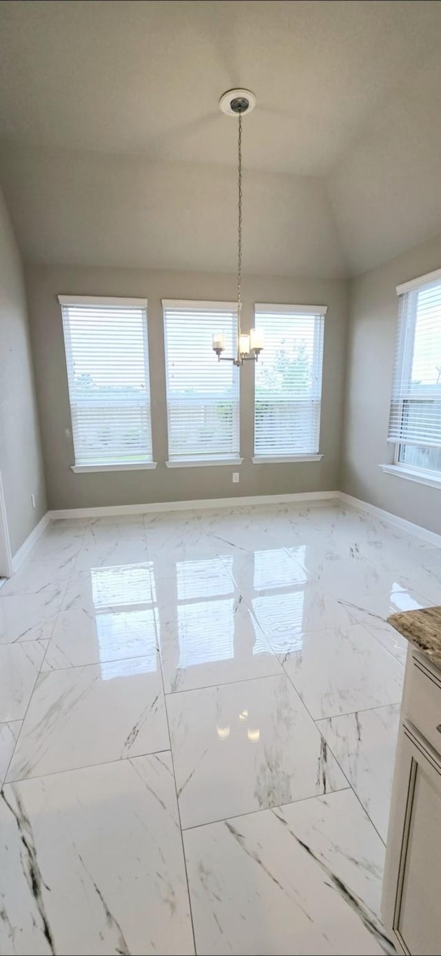 2711 Wollemi Pine Trl, Katy, TX 77493 - unfurnished dining area featuring lofted ceiling, baseboards, marble finish floor, and a chandelier