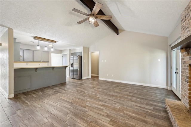 1117 Meadowland Dr, Beaumont, TX 77706 - unfurnished living room with wood finished floors, a textured ceiling, baseboards, and ceiling fan