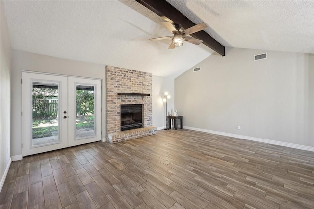 1117 Meadowland Dr, Beaumont, TX 77706 - unfurnished living room featuring wood finished floors, a ceiling fan, visible vents, and a textured ceiling