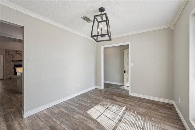 1117 Meadowland Dr, Beaumont, TX 77706 - unfurnished dining area with wood finished floors, a chandelier, visible vents, and a fireplace