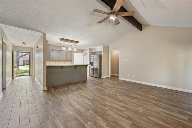 1117 Meadowland Dr, Beaumont, TX 77706 - unfurnished living room with wood finished floors, a textured ceiling, baseboards, and ceiling fan