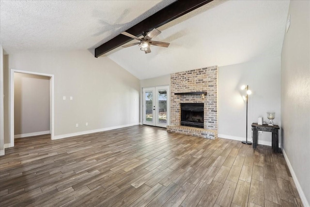 1117 Meadowland Dr, Beaumont, TX 77706 - unfurnished living room with wood finished floors, lofted ceiling with beams, ceiling fan, baseboards, and a brick fireplace