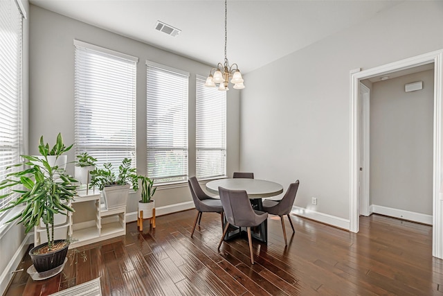 dining room with visible vents, baseboards, and dark wood-style floors