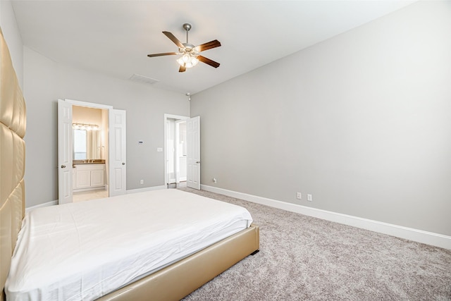 bedroom with ceiling fan, baseboards, carpet flooring, and ensuite bathroom