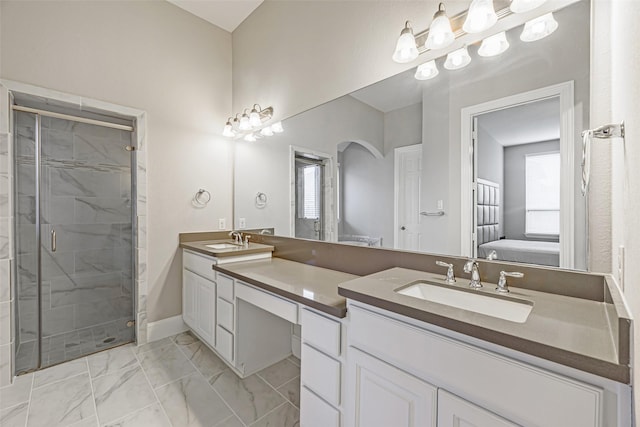full bath featuring double vanity, marble finish floor, a stall shower, and a sink