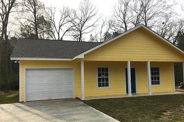 view of front of house featuring driveway, roof with shingles, and a garage