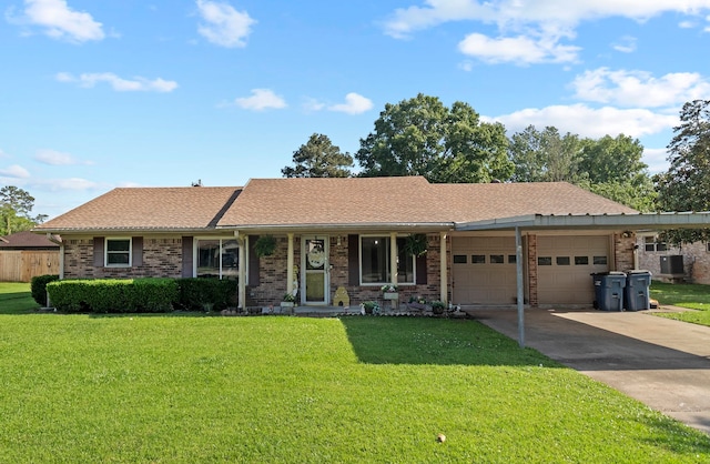 ranch-style house featuring an attached garage, driveway, a front lawn, and brick siding