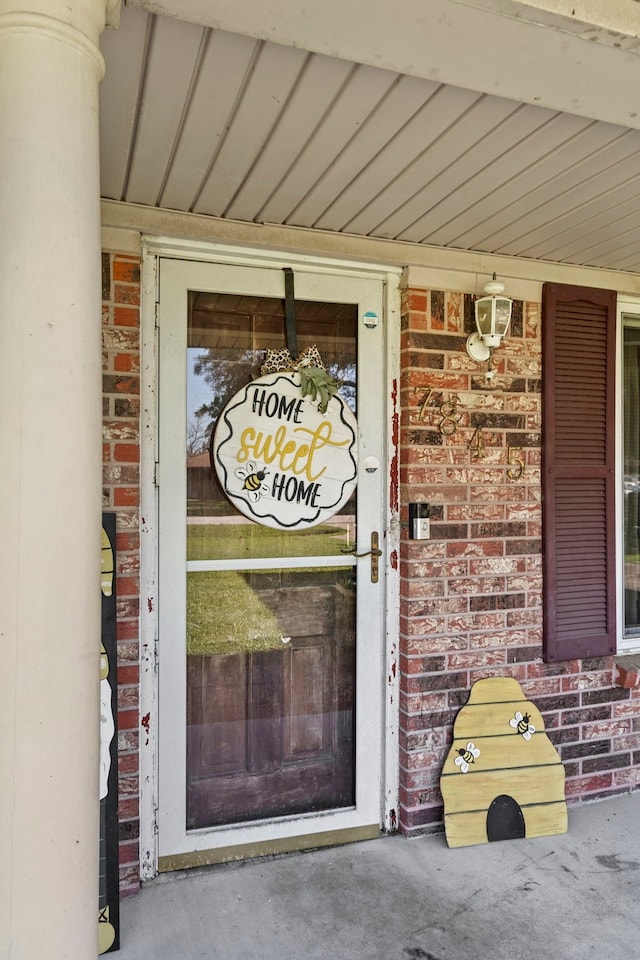property entrance with brick siding