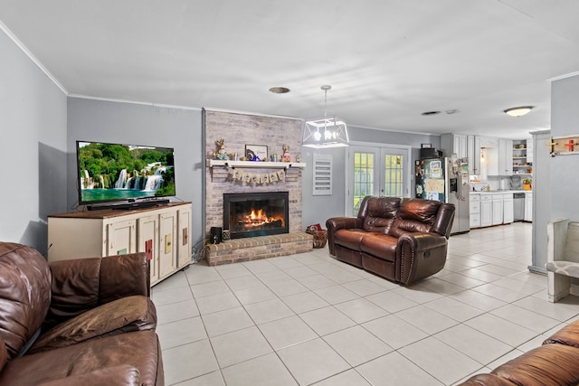 living area featuring french doors, ornamental molding, a brick fireplace, and light tile patterned floors