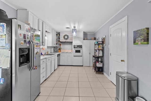 kitchen with crown molding, open shelves, white appliances, and light tile patterned floors
