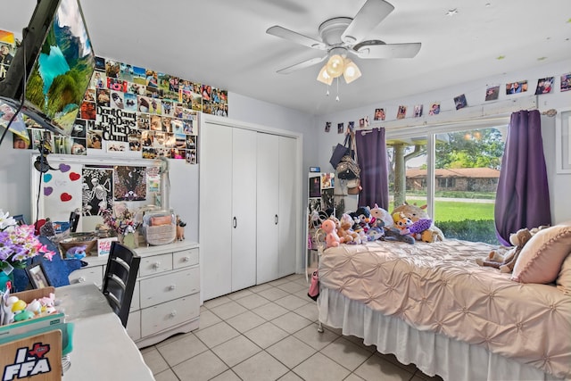 bedroom with a ceiling fan, a closet, and light tile patterned floors