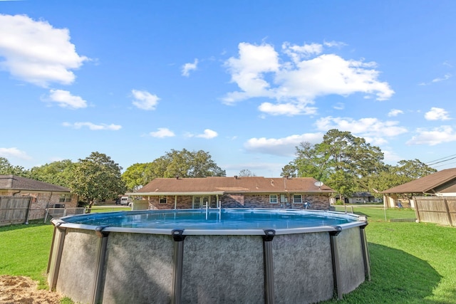 view of swimming pool with fence, a yard, and a fenced in pool
