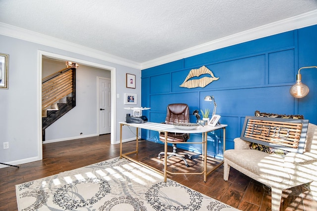 office with wood finished floors, a decorative wall, crown molding, baseboards, and a textured ceiling