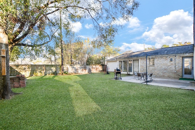 view of yard with a fenced backyard and a patio area