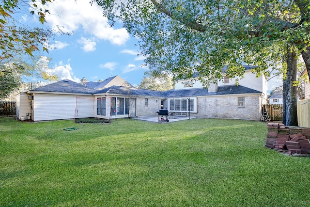 back of house featuring a yard, a patio area, and fence