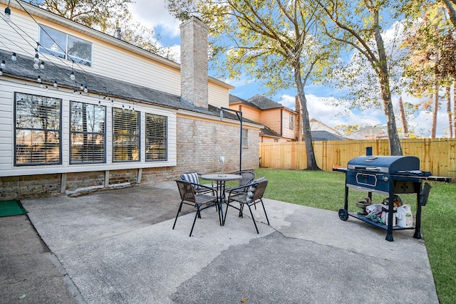 view of patio with a fenced backyard, grilling area, and outdoor dining area