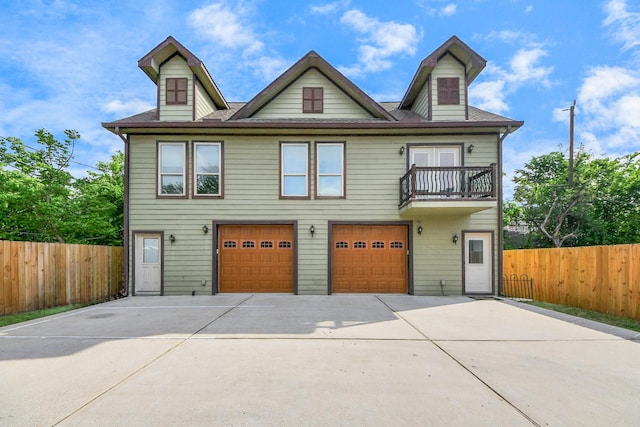 1561 Scharpe St, Houston, TX 77023 - view of front of home with fence, a shingled roof, a balcony, concrete driveway, and an attached garage