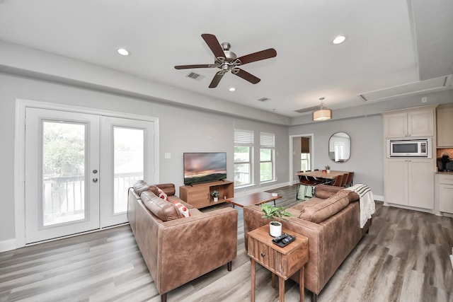 1561 Scharpe St, Houston, TX 77023 - living area featuring attic access, light wood-style floors, visible vents, and french doors