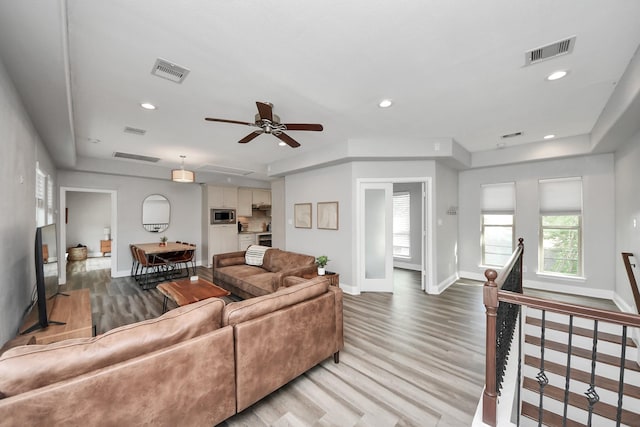 1561 Scharpe St, Houston, TX 77023 - living room featuring visible vents, light wood finished floors, and baseboards